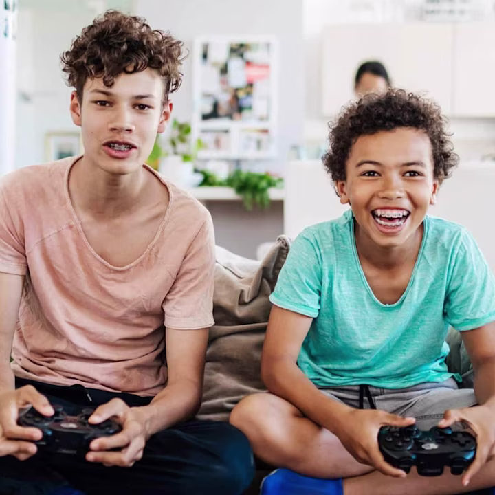 two teen boys playing video games