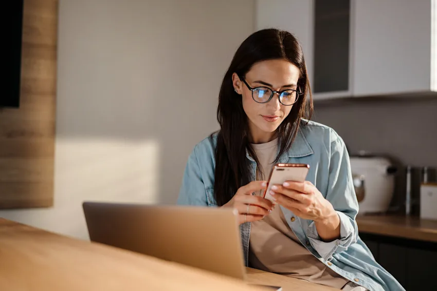 Woman using her phone at home