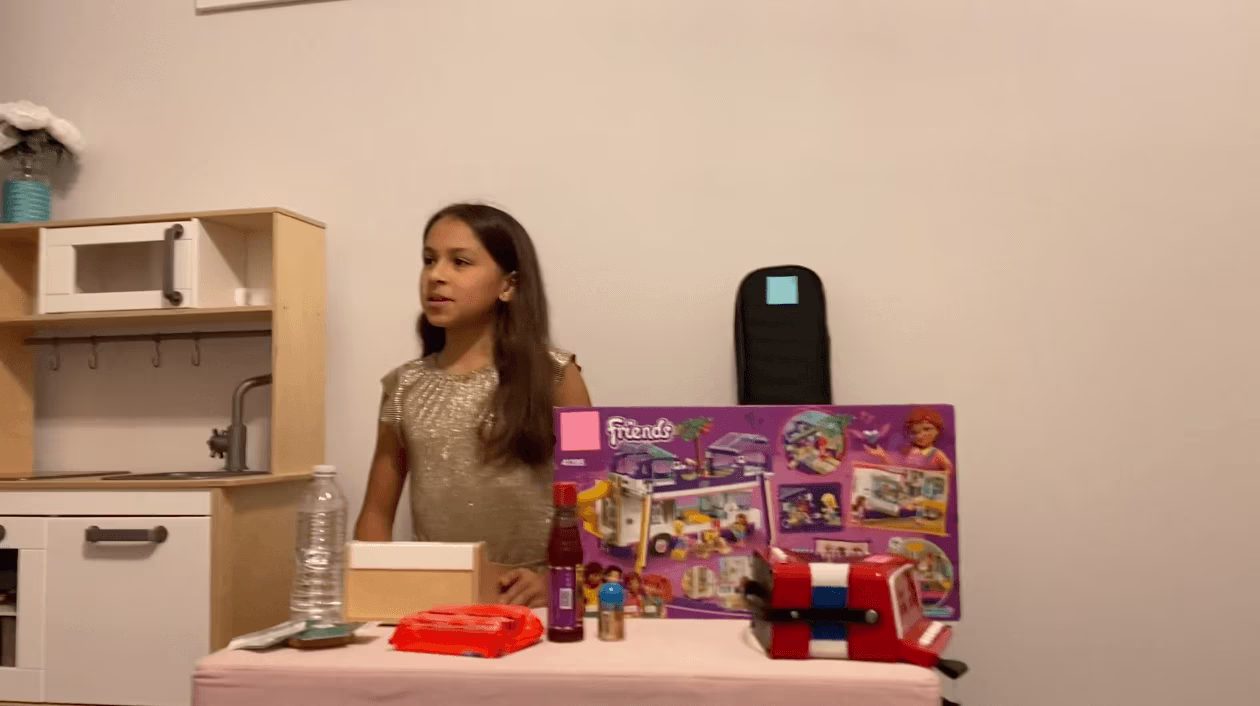 girl at a table with toys