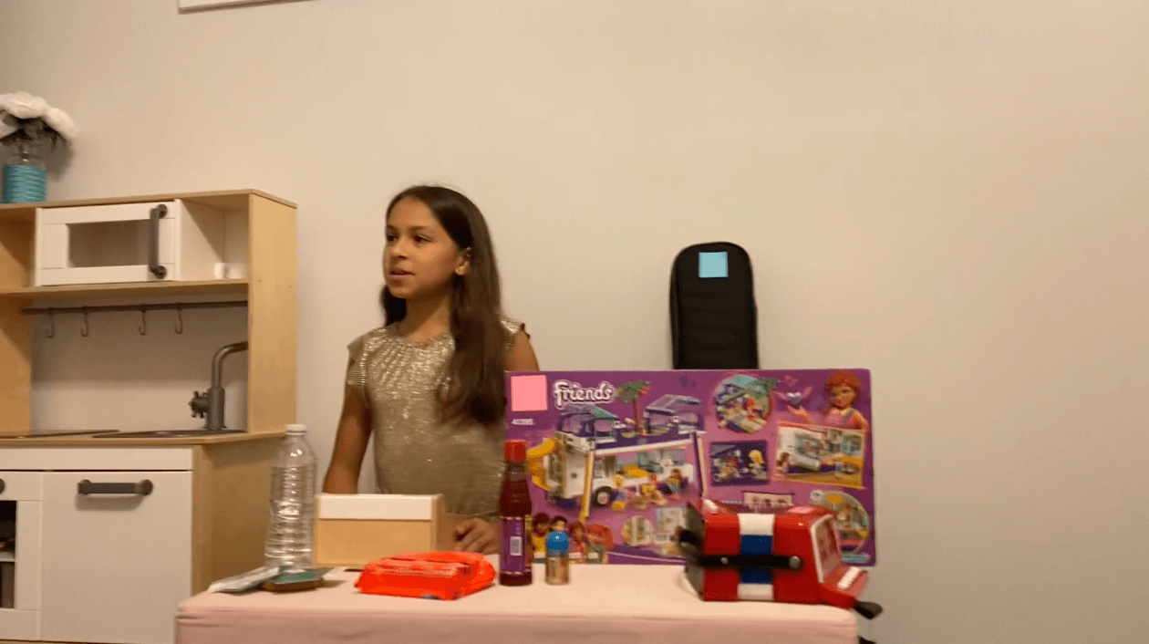 girl at a table with toys