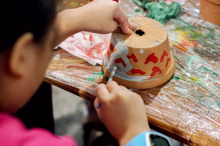 Mothers day crafts: kid painting a flowerpot