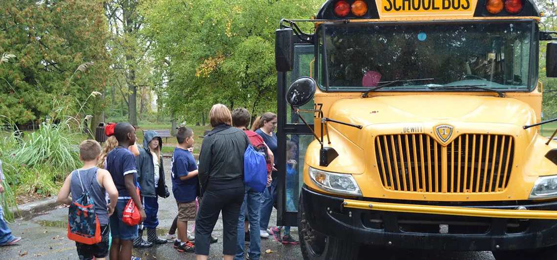 kids getting on a school bus