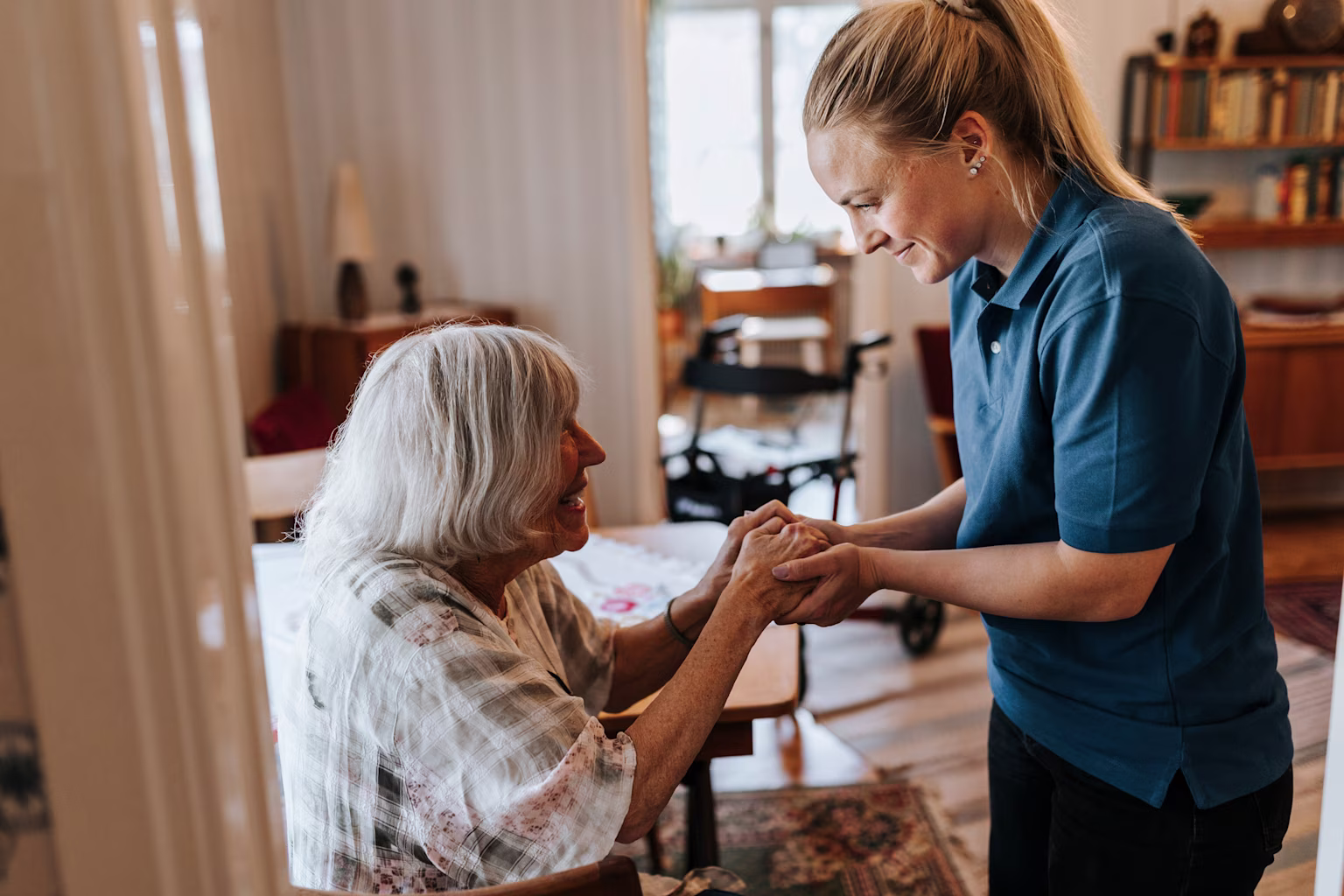 Young woman helping an elderly woman.