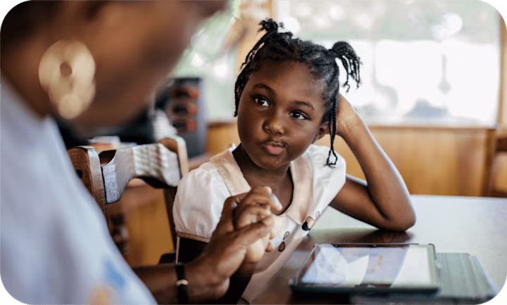 daughter looks up at mother as she grabs her hand