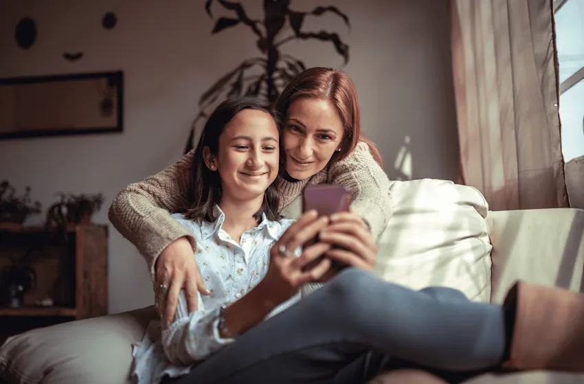 Mom and teen daughter using cellphone