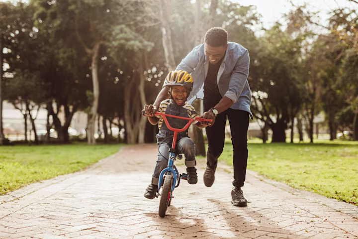 boy on bike with dad