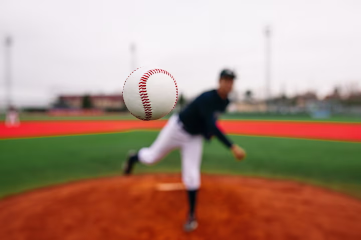 Close up of baseball being thrown from the pitcher's mound.
