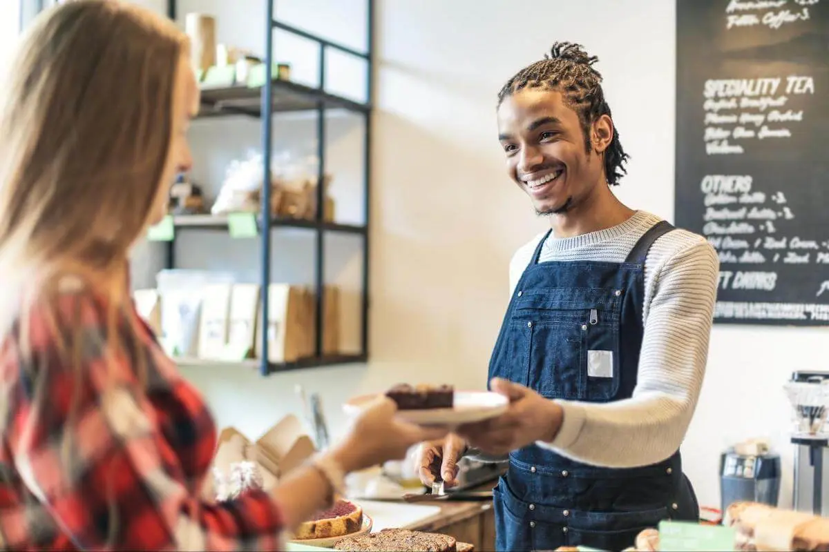 Customer getting her order from a barista