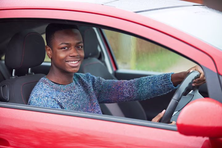 Man driving a red car