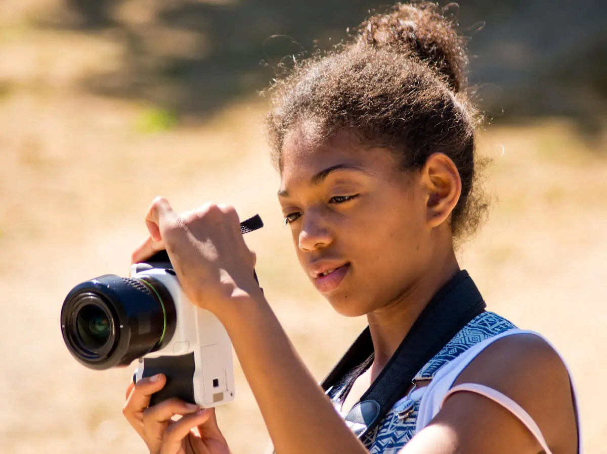 Jobs for 11 year olds: girl using a camera