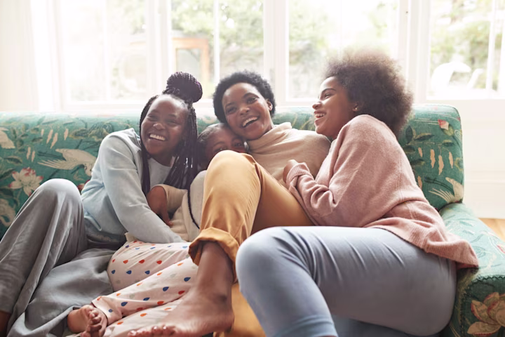 Mother laughing with children on couch