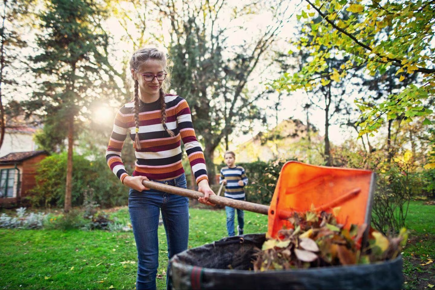Best jobs for teens: teenager using a plastic shovel to clean their garden