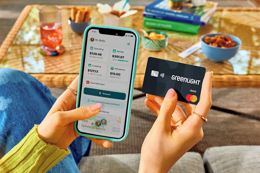greenlight product holding debit card desktop hero