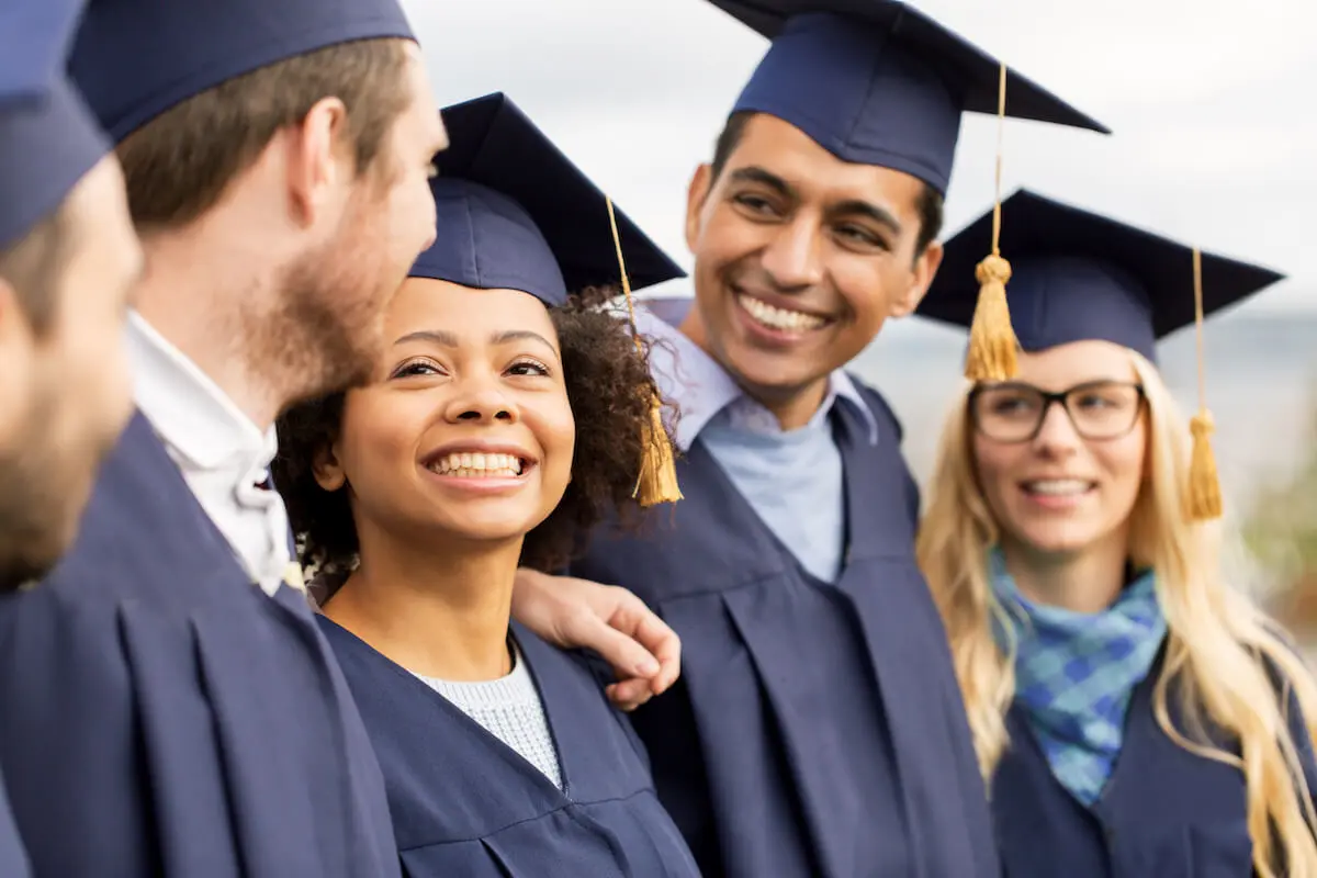 Average student loan debt: graduates smiling at each other