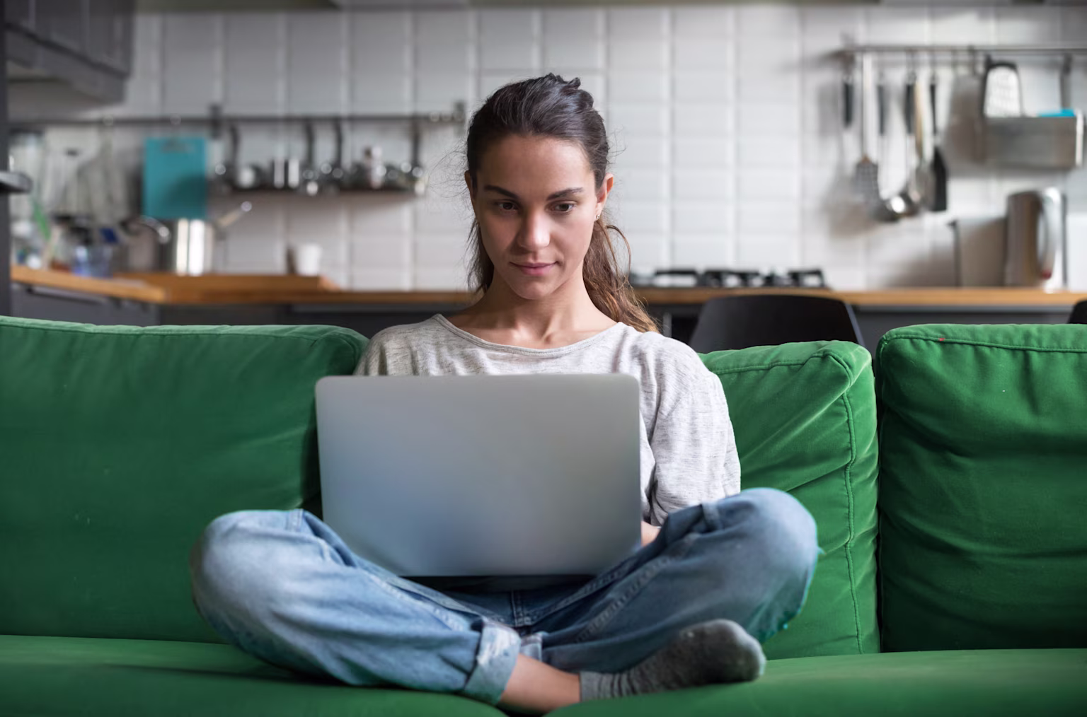 Greenlight teen girl looking at federal financial aid application to help with college costs