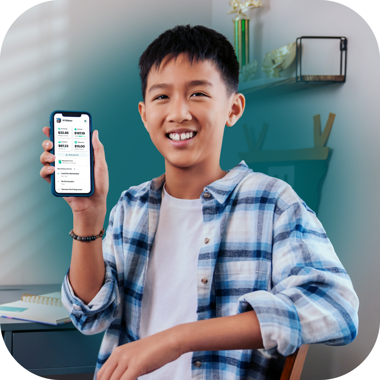 Boy holding phone with Greenlight app 
