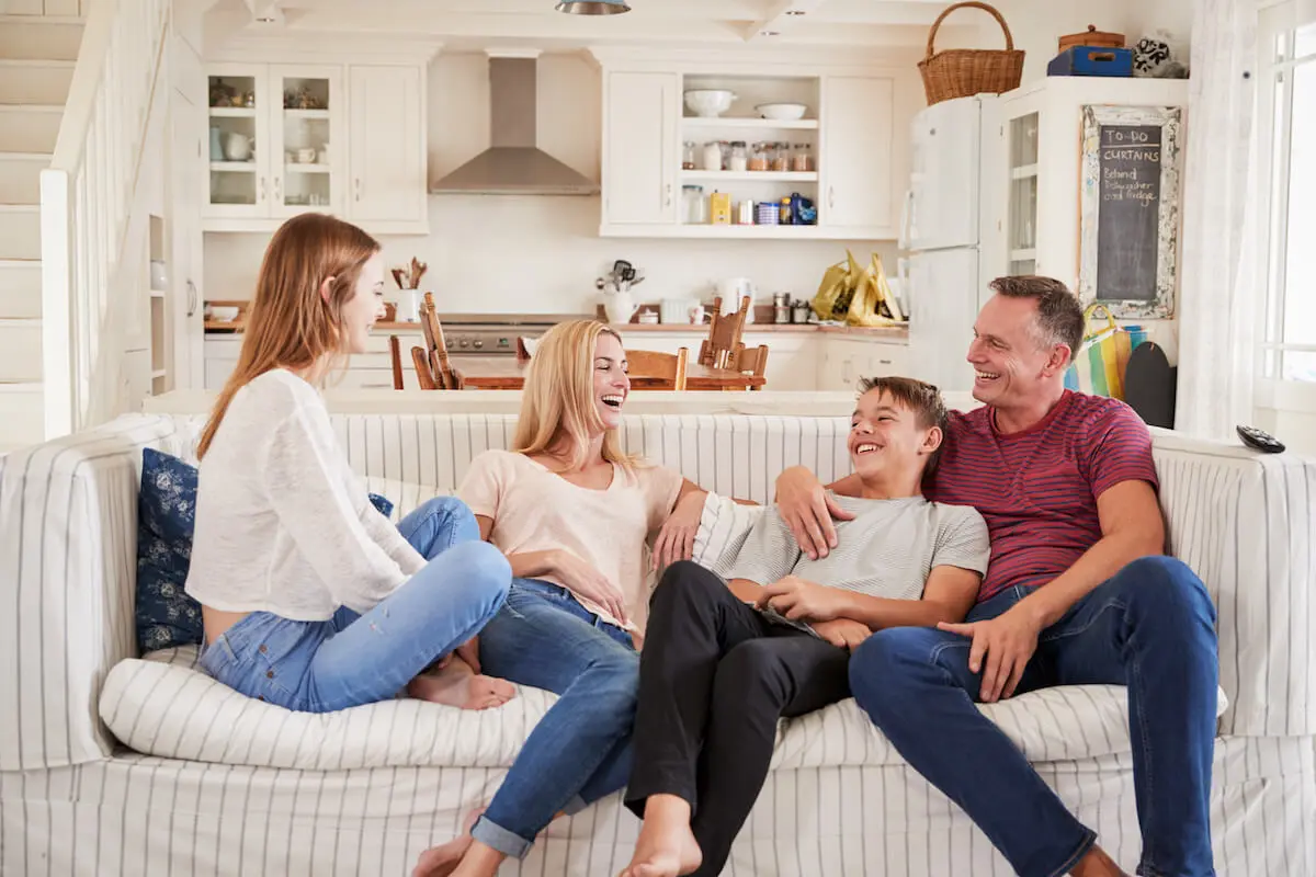 Family happily relaxing in their living room
