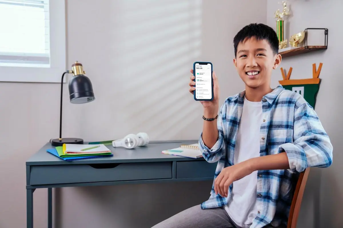 Boy showing his phone to the camera