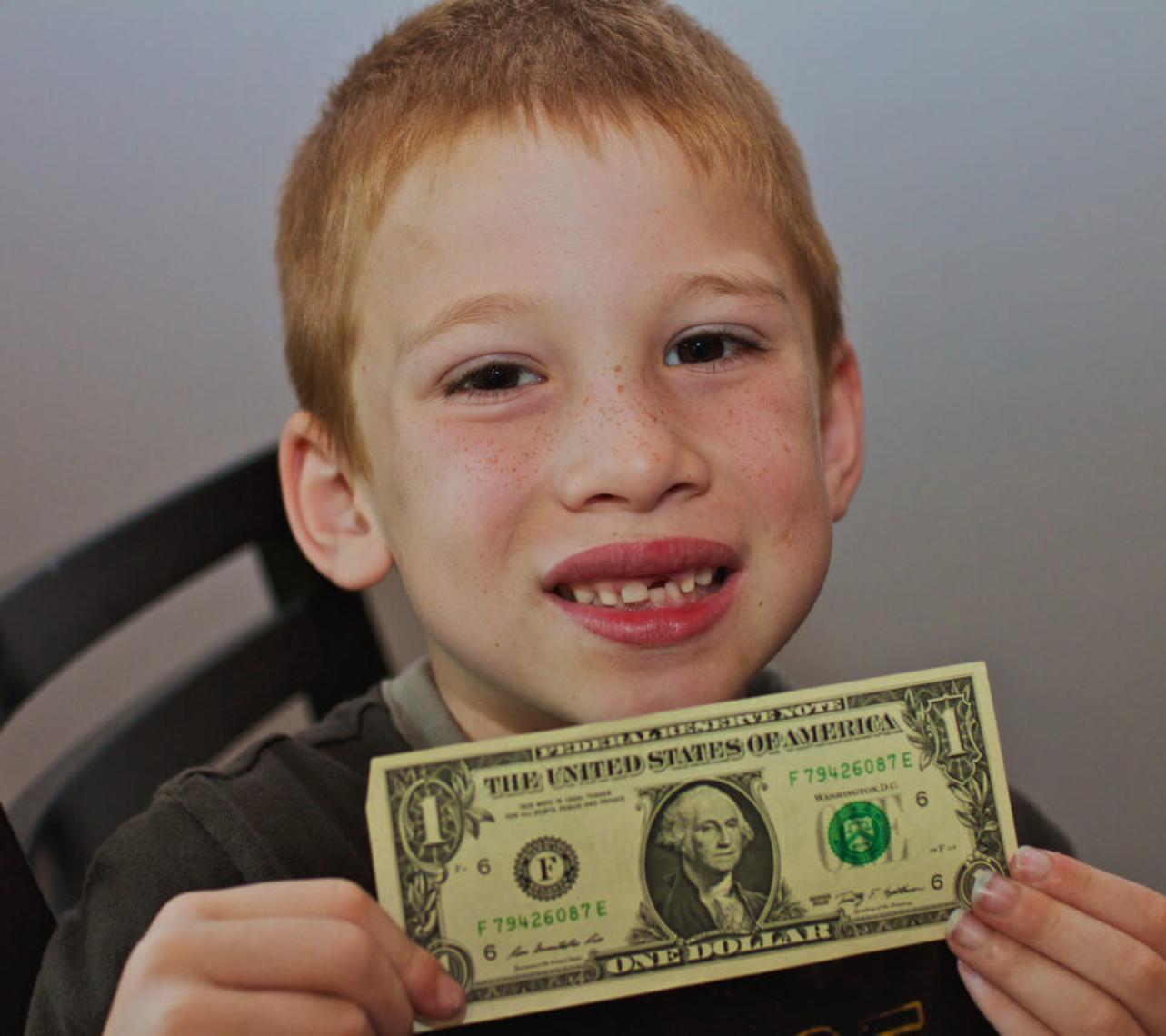 kid holding a dollar bill