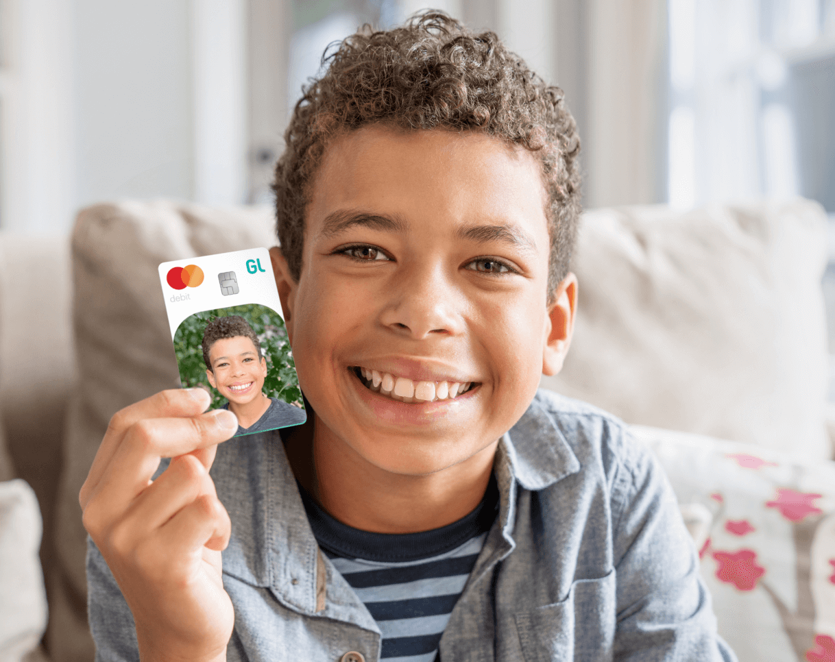 teen boy holding a greenlight custom debit card