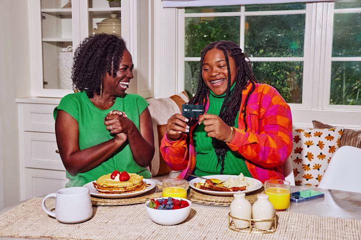 Two women talking in the kitchen.
