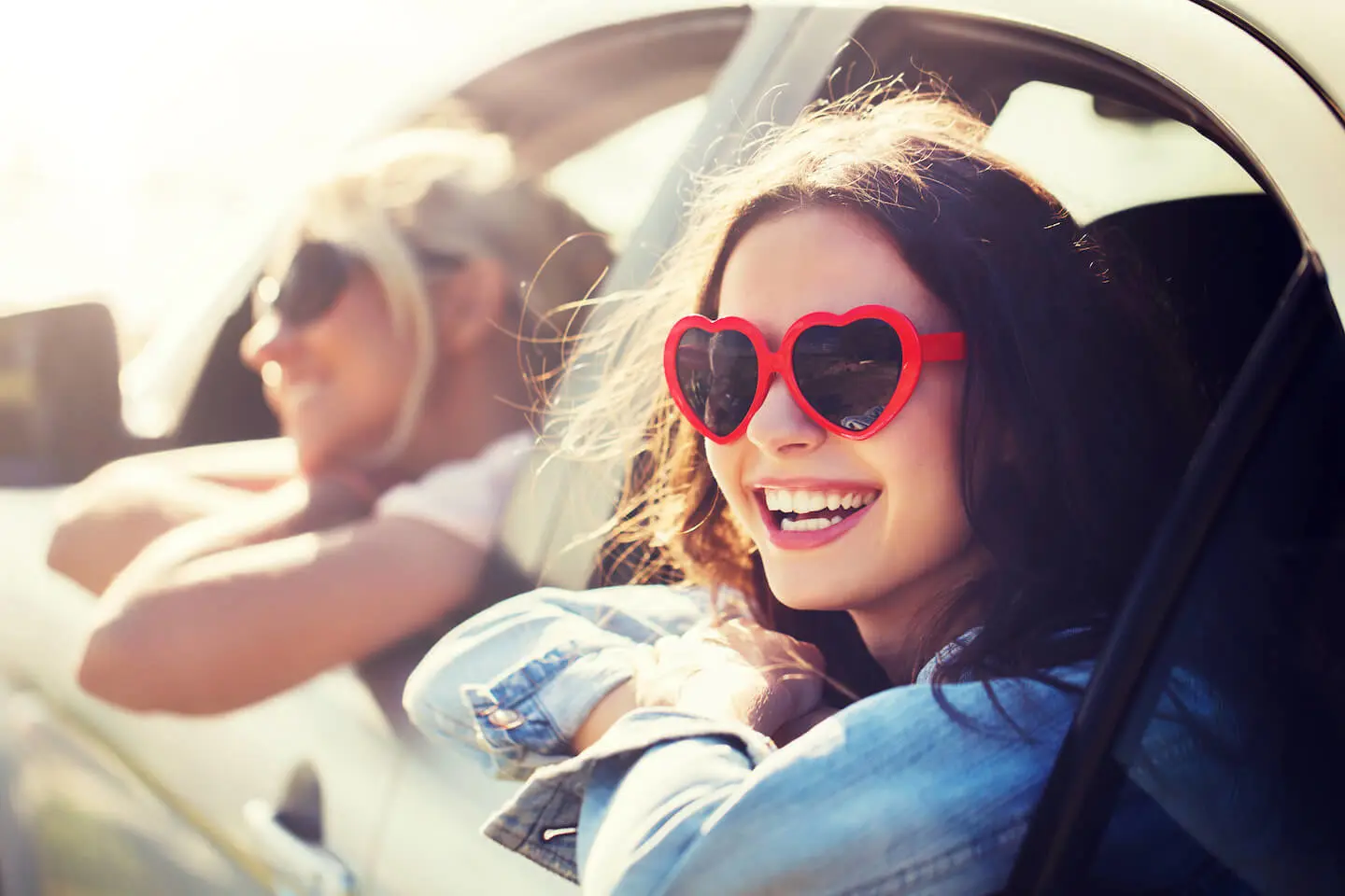 Is it better to lease or buy a car: woman wearing a pair of heart-shaped sunglasses
