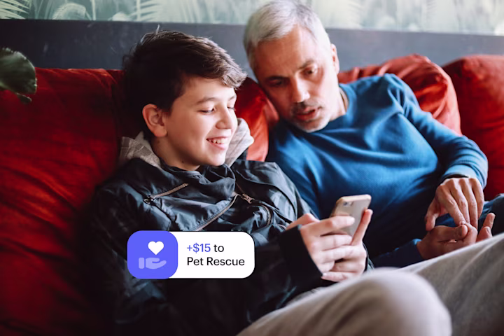 Dad and son donating money to charity