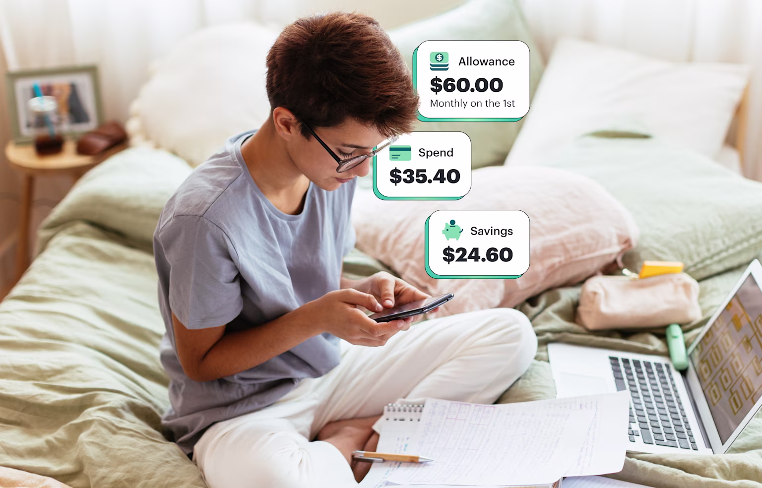 Young boy checks his Greenlight financial literacy app with allowance and savings in his bedroom