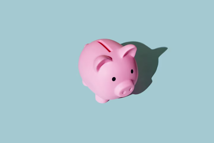 Pink piggy bank with blue background. 
