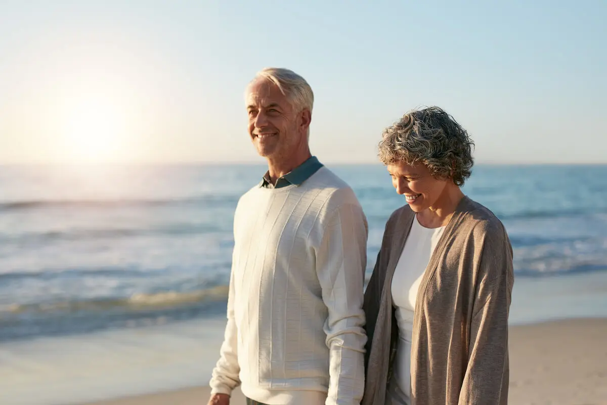 Senior couple walking at a beach