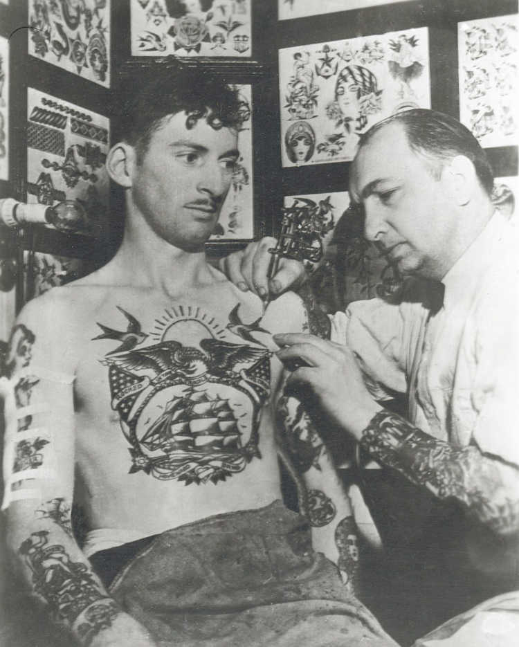 History of Tattoos L. M. Brown, a sailor, getting tattooed by Owen Jenson.