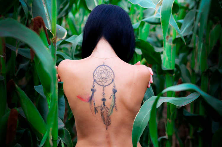Indian Warrior dream catcher tattoo on back of woman