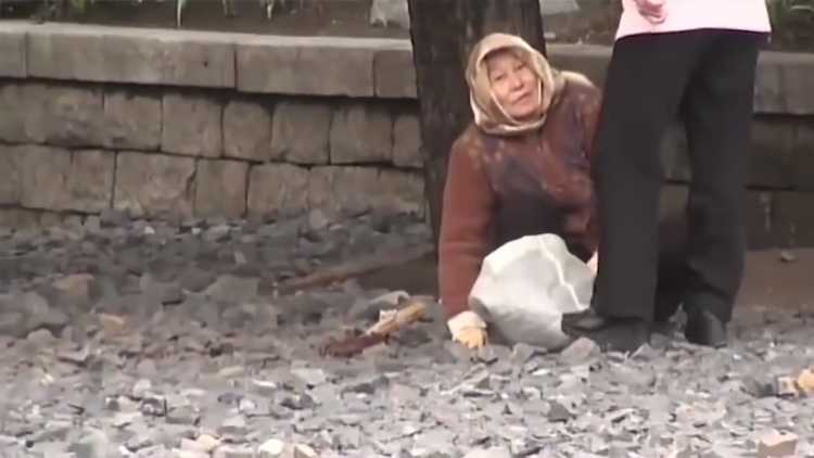 old lady cleaning stones north korea