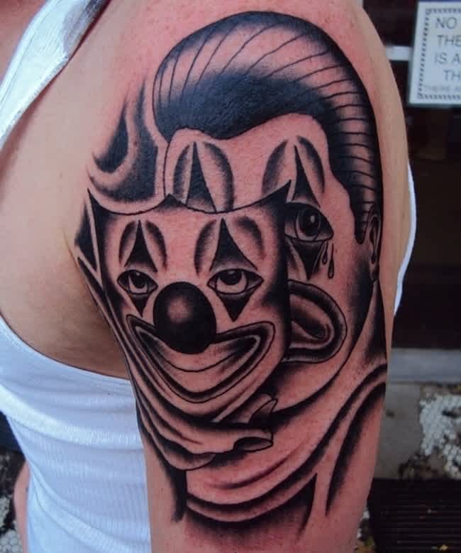 Clown mask tattoo on shoulder