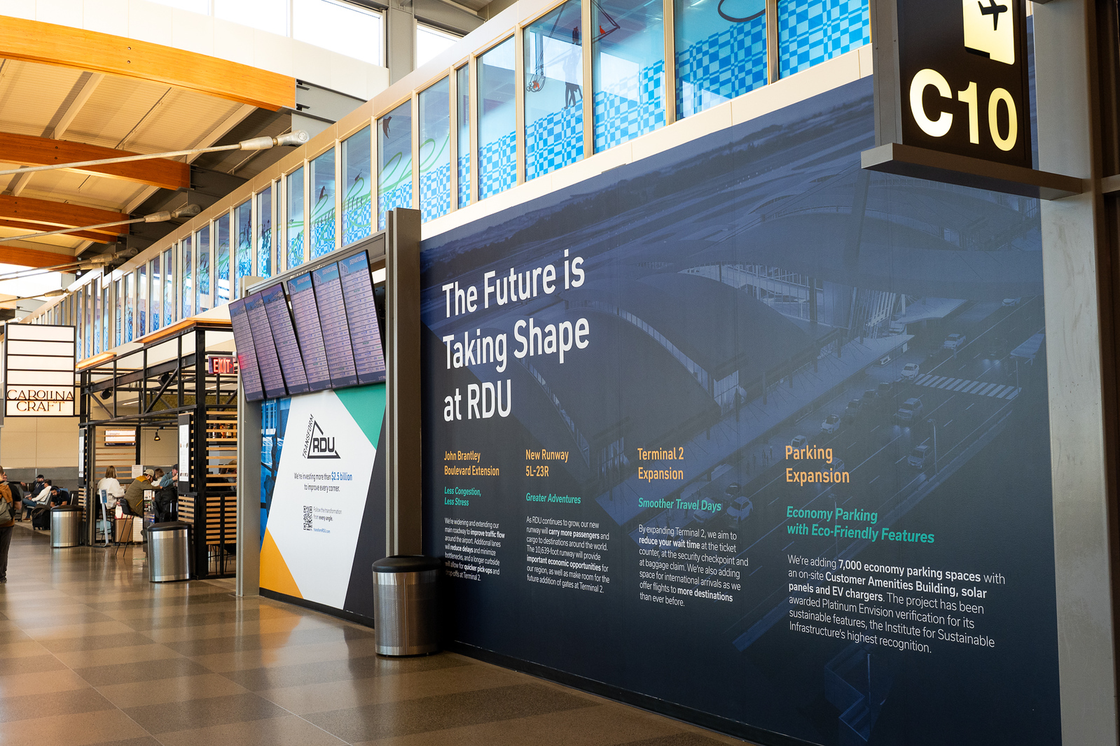 Airport terminal display showing Transform RDU expansion projects