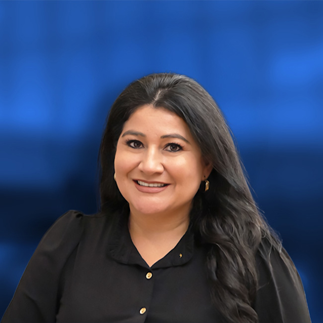 Woman with long dark hair wearing black shirt smiling at camera against blue background