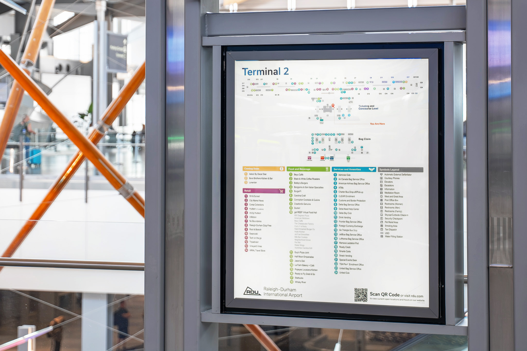 Terminal 2 airport map display showing gates, dining, retail, and services with color-coded legend at Raleigh-Durham Airport.
