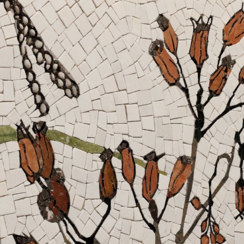 Mosaic artwork depicting orange seed pods on black stems with green leaves against a white tiled background.