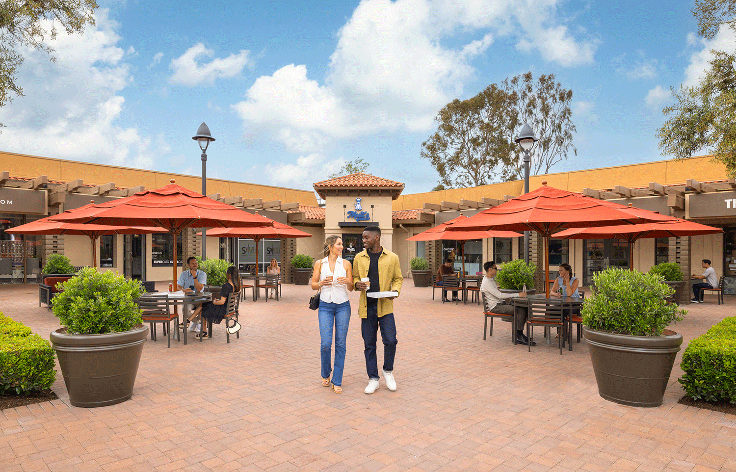  Couple walking in the courtyard at Eastbluff Village Center 