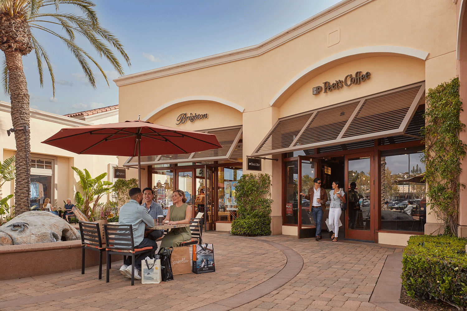  View of people in the courtyard at Corona del Mar Plaza