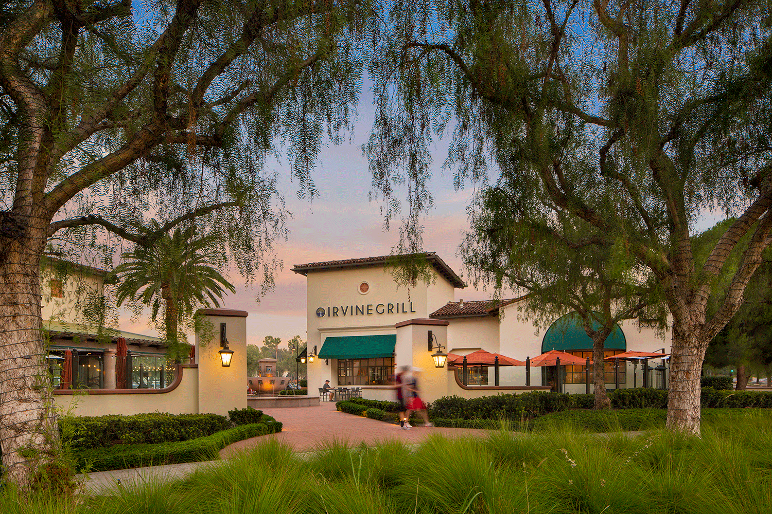  Exterior view of Quail Hill® Shopping Center at dusk