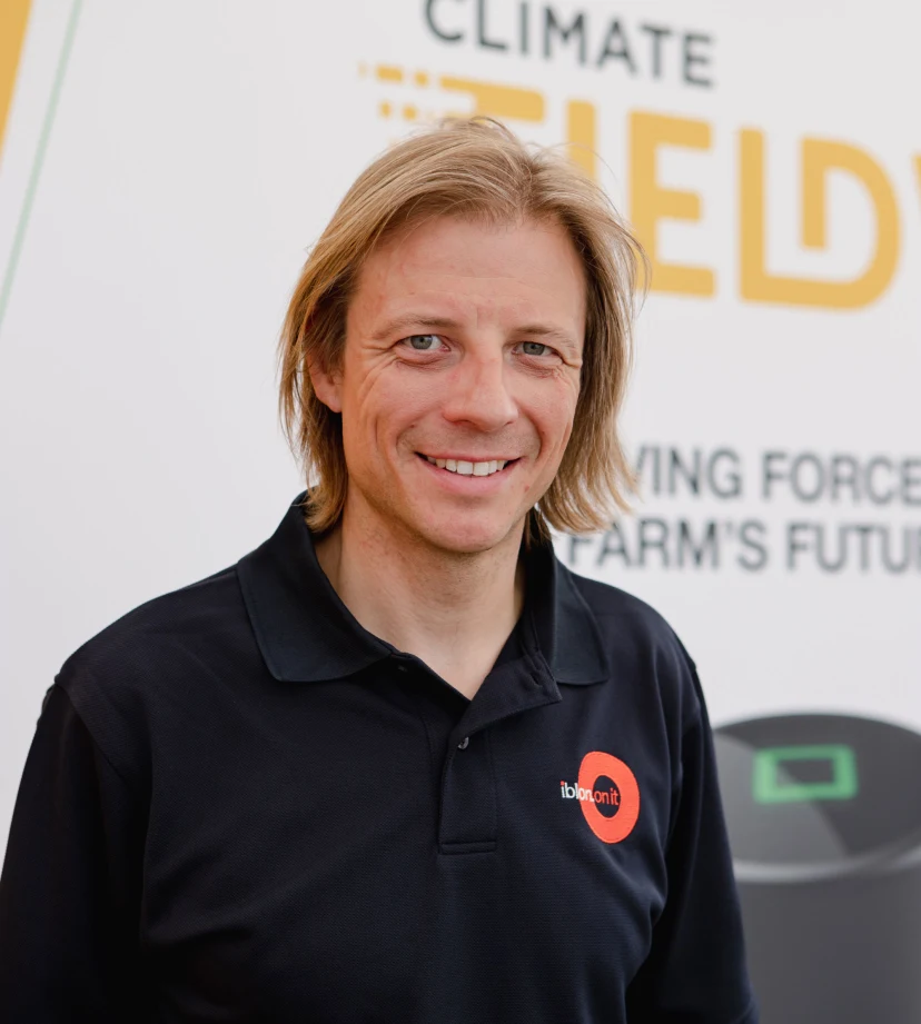 Man smiling stood in a crop field with a field view tshirt