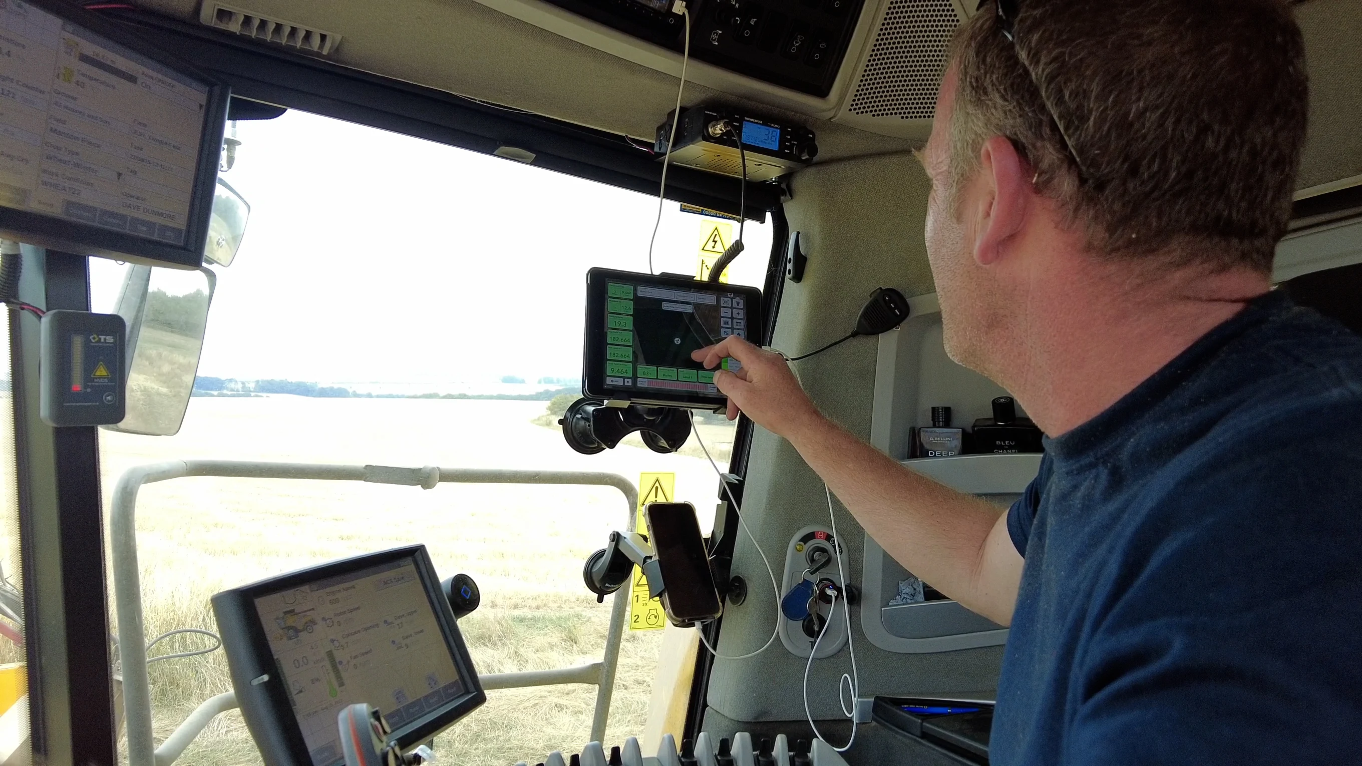 Man in tractor using software