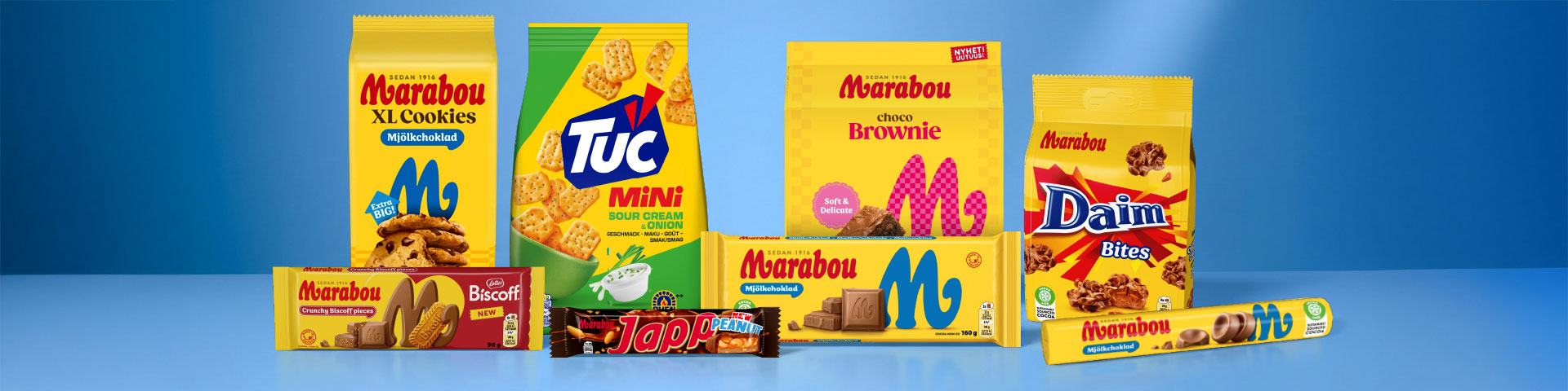 Förpackningar med Marabou XL Cookies, Tuc Mini kex, Marabou Brownie, Daim Bites, Marabou mjölkchoklad samt chokladkakor med Biscoff och Japani, uppställda tillsammans. Klicka för att handla.