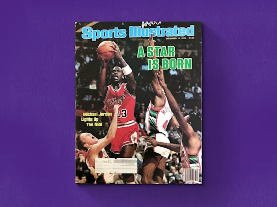 An image of Michael Jordan's full Bulls uniform debut on the cover of Sports Illustrated, dated December 10, 1984, on a purple background