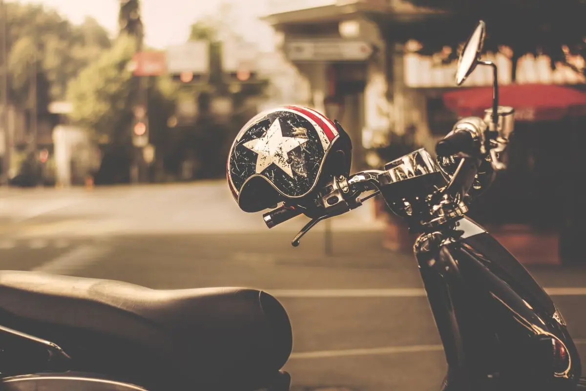 Black and Gray Motor Scooter With Black and White Star Print Half Face Helmet
Photo by Lum3n
