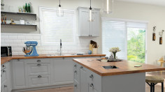 A kitchen showcasing automated Sheer Shadings on the window and sliding door.