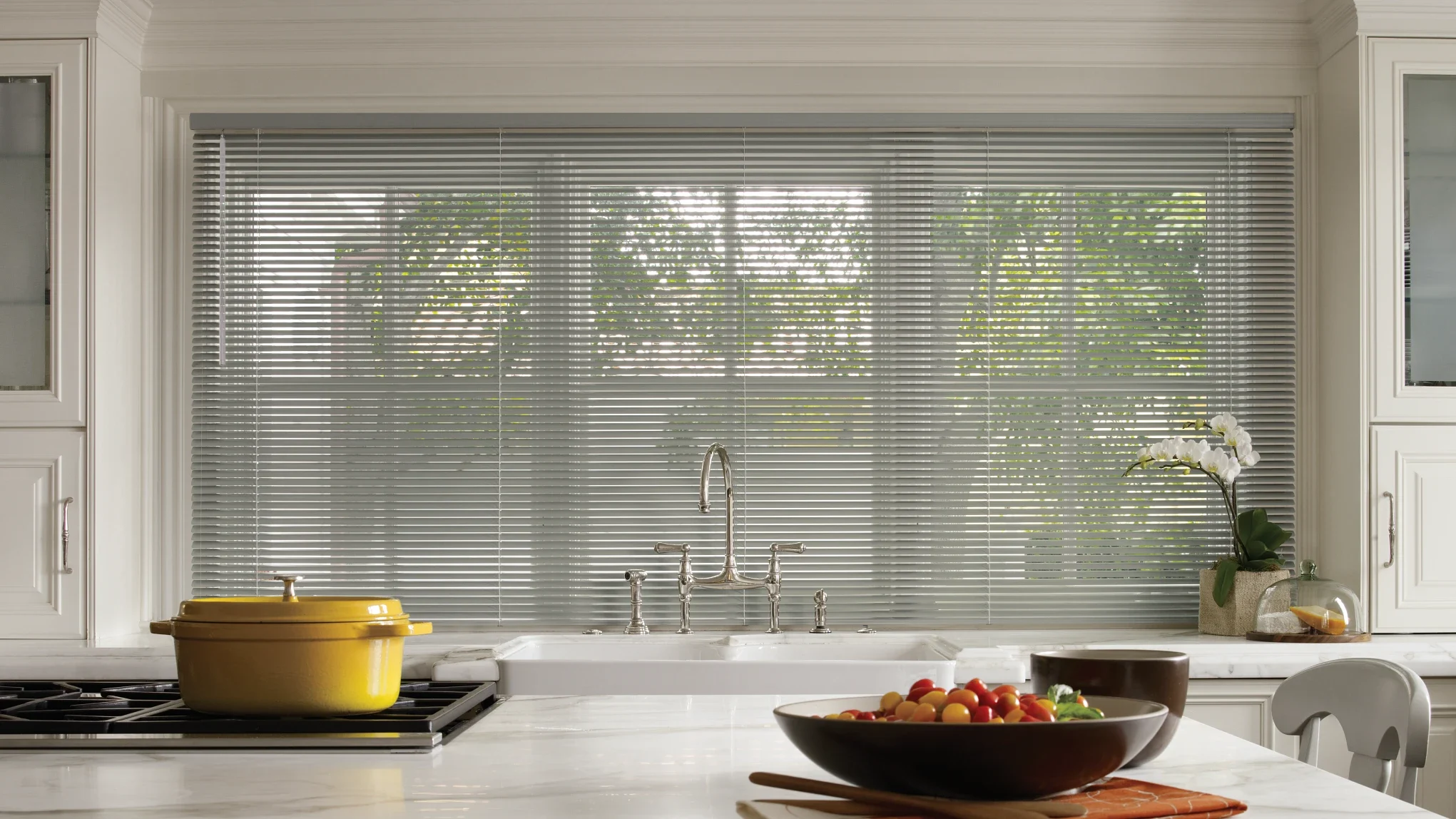 Grey aluminum blinds in a kitchen.