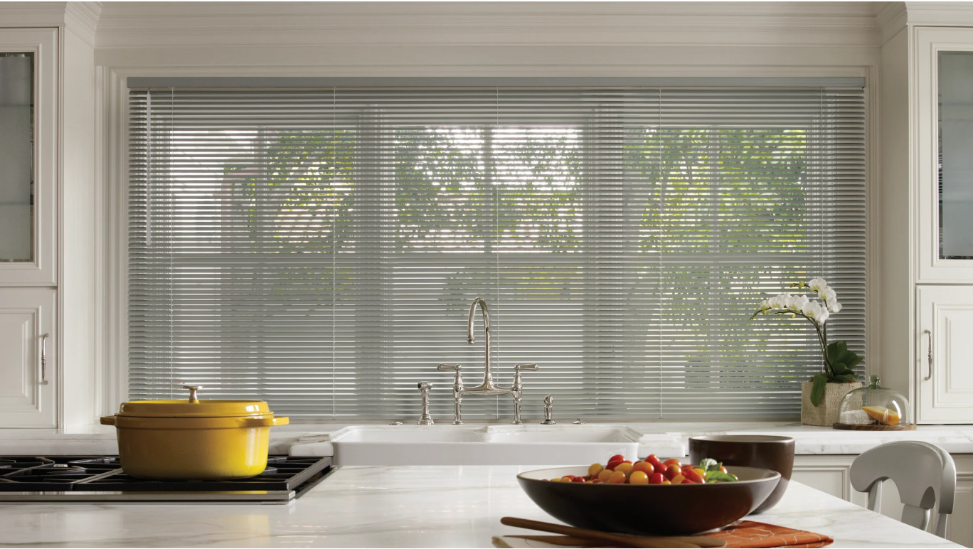 Grey aluminum blinds in a kitchen.