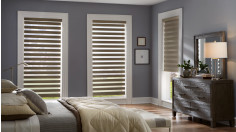 Three motorized banded shaded on tall windows in a bedroom.